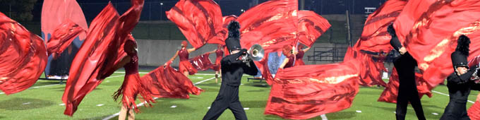Rockford color guard and band students in a flurry of red and black